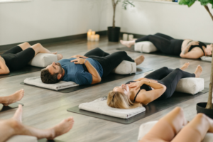 Corporate yoga session in Toronto Team practicing mindfulness and relaxation at OHA Wellness studio in Liberty Village